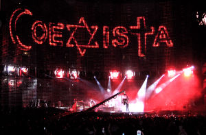 U2 during the song "Sunday Bloody Sunday" in Mexico City, February 16, 2006.  Notice the symbols of Islam, Judaism and Christianity inside the word "Coexista".
